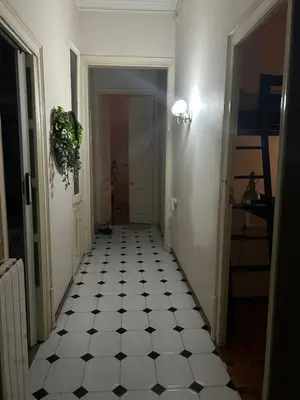 a hallway with a black and white tiled floor at Luz's Hut in Barcelona