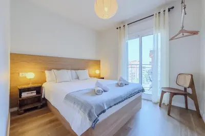 a bedroom with a large bed and a large window at Apartamento exclusivo en Sant Antoni in Barcelona