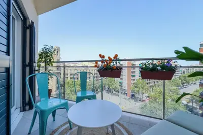 a balcony with a table and chairs and a view of a city at Apartamento exclusivo en Sant Antoni in Barcelona
