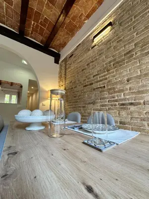 a dining room with a table with chairs and a television at Sant Pau Modernista in Barcelona