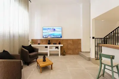 a living room with a couch and a table at Mediterranean Bliss in Sant Adria de Besos