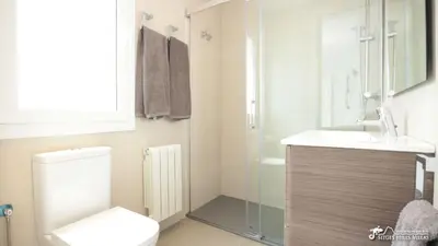 a small white balcony with a table and two chairs at Charming Casa in Sitges centre & minutes to beach in Sitges