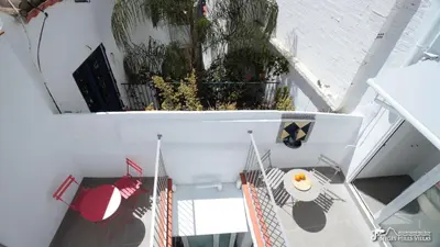 an overhead view of a spiral staircase with a plate of food at Charming Casa in Sitges centre & minutes to beach in Sitges