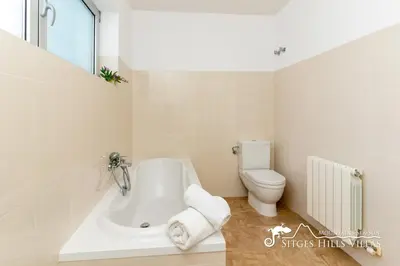 a bathroom with a shower and a tub and a sink at Villa Lucere with private pool near Sitges in Olivella
