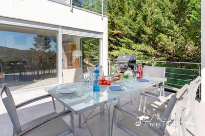 a living room with a couch and a table at Villa Lucere with private pool near Sitges in Olivella