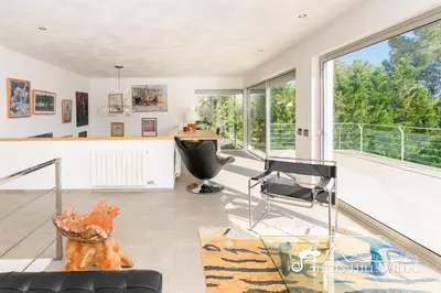 a patio with an umbrella and chairs and a pool at Villa Lucere with private pool near Sitges in Olivella
