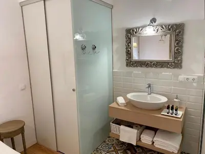 a bathroom with a sink and a mirror at Bed & Breakfast Wine & Cooking Penedès in Pla del Panadés