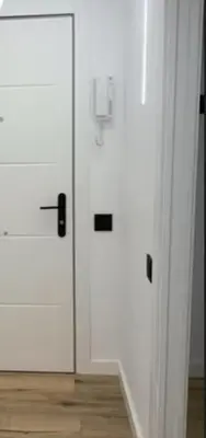 two white doors in a room with a wooden floor at Vidanova 1 in Vilanova i la Geltrú