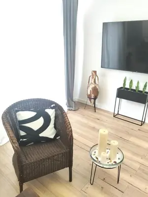 a living room with a chair and a table with candles at Vidanova 1 in Vilanova i la Geltrú