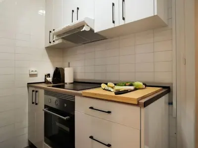 a kitchen with a cutting board on a counter at Renovated Apartment in Vila de Gràcia in Barcelona