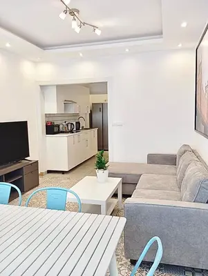 a living room with a couch and a table at Warm Harbor in Santa Coloma de Gramanet