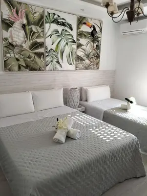 two beds in a room with two beds sidx sidx sidx at Warm Harbor in Santa Coloma de Gramanet