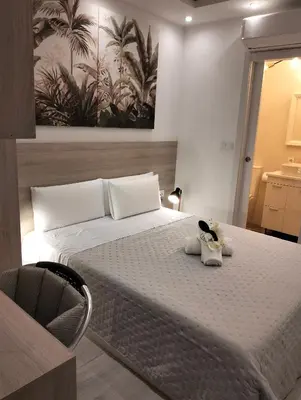 a bedroom with a bed with two stuffed animals on it at Warm Harbor in Santa Coloma de Gramanet