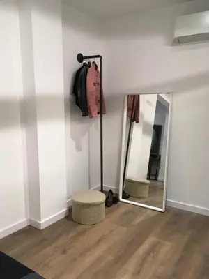 a bedroom with clothes hanging on a rack at Loft reformado in Cornellà de Llobregat