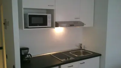 a small kitchen with a sink and a microwave at Marbel 2 in Barcelona