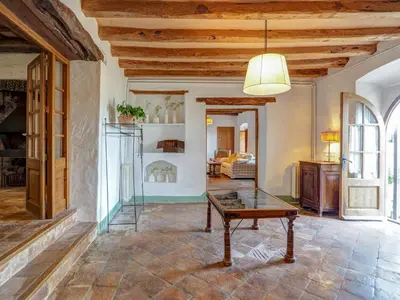 a living room with a table and a couch at Masia Palou Alt by Hello Homes Sitges in Sitges