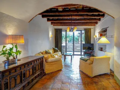 a living room with couches and a table at Masia Palou Alt by Hello Homes Sitges in Sitges