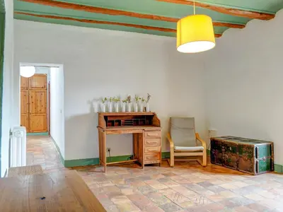 a room with a desk and a chair and a table at Masia Palou Alt by Hello Homes Sitges in Sitges