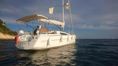 a white boat in the water on the ocean at Velero Viko S30 in Sitges