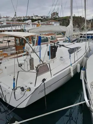 a white boat is docked in a harbor at Velero Viko S30 in Sitges