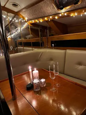 a table with candles and wine glasses on a boat at Velero Draco in Sitges