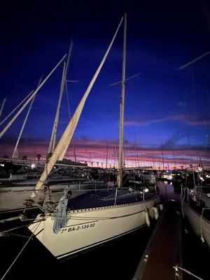 a group of boats docked in a marina at night at Velero Draco in Sitges
