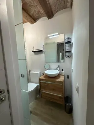 a bathroom with a sink and a toilet and a mirror at Stay Happy in Barcelona