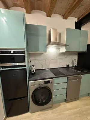 a kitchen with a washing machine and a dishwasher at Stay Happy in Barcelona