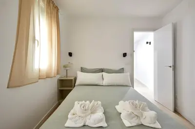 a bedroom with a bed with towels on it at 17 Nice apartment next to El Molino in Barcelona