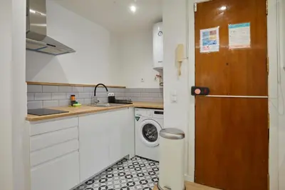a small kitchen with a washer and dryer in it at 17 Nice apartment next to El Molino in Barcelona