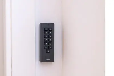 a remote control hanging on a white door at StayCampNou 1BR with Balcony in Hospitalet de Llobregat
