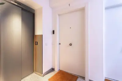 a hallway with two elevators and a door at StayCampNou 1BR with Balcony in Hospitalet de Llobregat