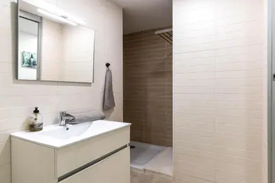 a bathroom with a sink and a shower at Acogedor apartamento Diagonal Mar in Barcelona