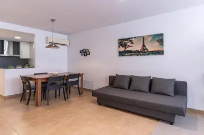a living room with a couch and a table at Acogedor apartamento Diagonal Mar in Barcelona