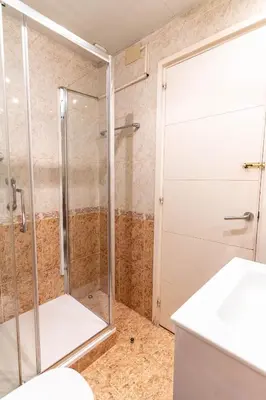 a shower with a glass door in a bathroom at Bonito apartamento Camp Nou in Barcelona