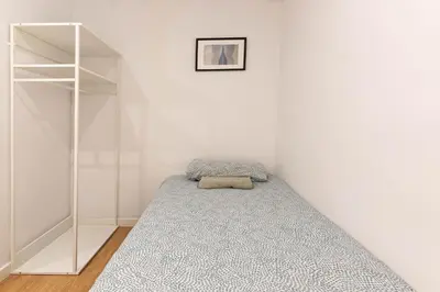 a bedroom with a bed and a book shelf at Lindo apartamento Montjuïc in Barcelona