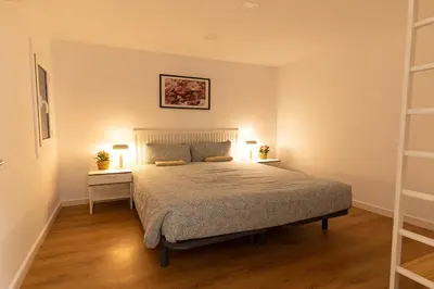 a bedroom with a bed with two night stands and two lamps at Lindo apartamento Montjuïc in Barcelona
