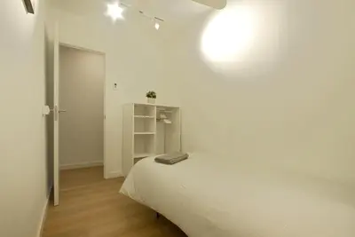 a white bedroom with a bed and a white closet at Lovely and cozy apartments near Barcelona in Hospitalet de Llobregat