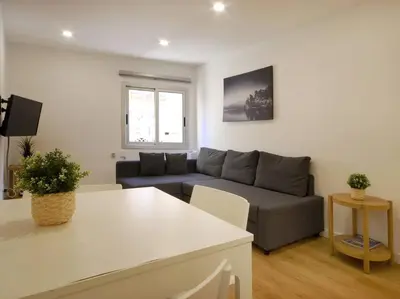 a living room with a couch and a table at Lovely and cozy apartments near Barcelona in Hospitalet de Llobregat
