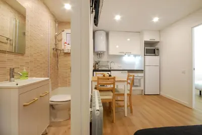 a small kitchen with a sink and a table in a room at Lovely and cozy apartments near Barcelona in Hospitalet de Llobregat