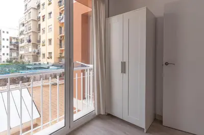 a room with a balcony with a door and a window at Hermoso apartamento en el centro in Barcelona