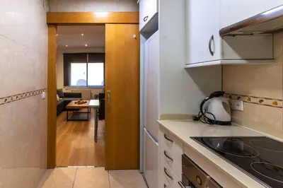 a kitchen with a door leading into a dining room at Nuevo apartamento zona Paseo de Gracia in Barcelona
