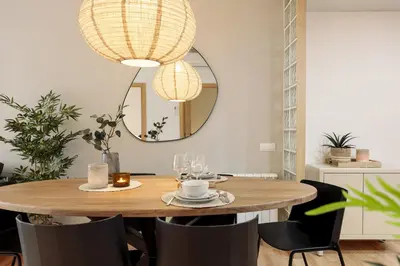 a dining room with a wooden table and a mirror at Precioso apartamento en el Centro in Barcelona