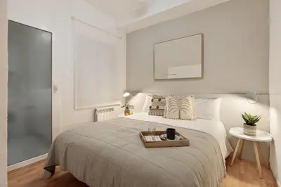 a bedroom with a bed with a tray on it at Precioso apartamento en el Centro in Barcelona