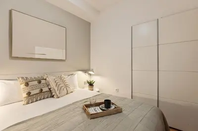 a bedroom with a large white bed with a tray on it at Precioso apartamento en el Centro in Barcelona