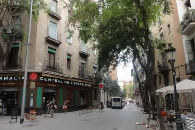 a city street with a bus driving down the street at EL born - spacious 2 bedrooms in Barcelona