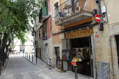 a street with a building and a shop with a balcony at EL born - spacious 2 bedrooms in Barcelona
