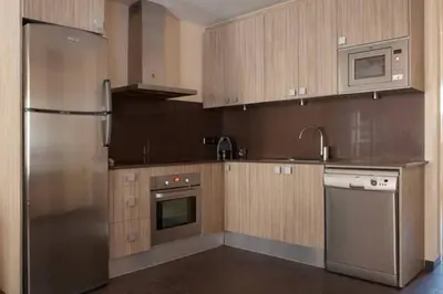 a kitchen with a stainless steel refrigerator and a dishwasher at EL born - spacious 2 bedrooms in Barcelona