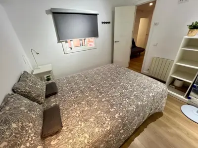 a bedroom with a bed and a flat screen tv at Charming and quiet apartments near Barcelona in Hospitalet de Llobregat