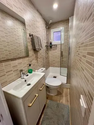 a bathroom with a white sink and a toilet at Charming and quiet apartments near Barcelona in Hospitalet de Llobregat